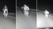 شاب يستلقي على دراجة نارية بطريقة استعراضية على طريق سريع بالوادي الجديد
