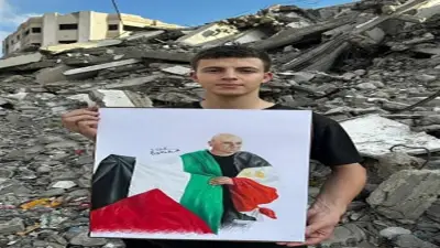 شاب فلسطيني يرسم لوحة لحسام حسن بين الأنقاض احتفاء برفع علم فلسطين